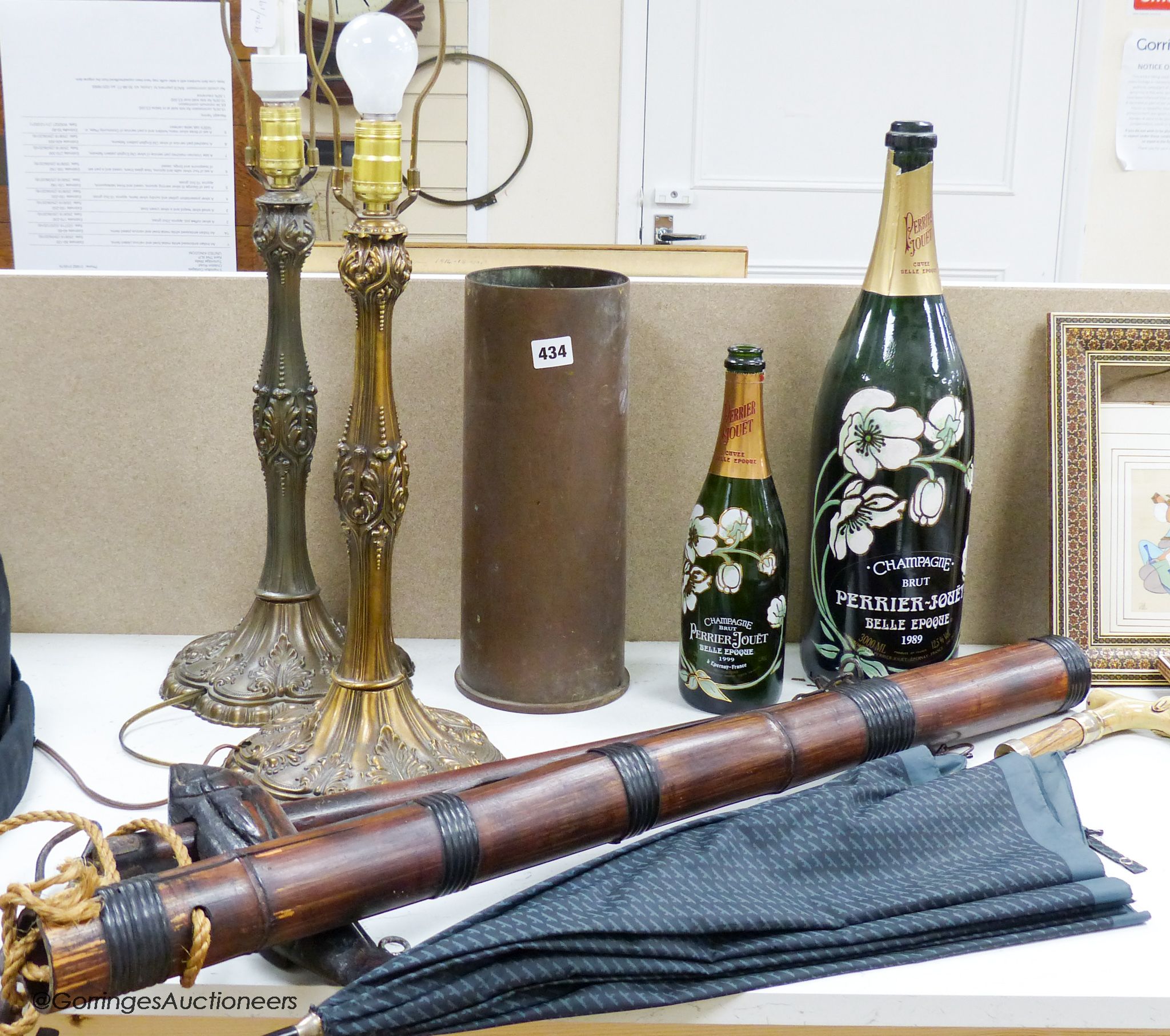 A pair of brass lamps, a dog handled umbrella, a shot casing, two display bottles of champagne etc